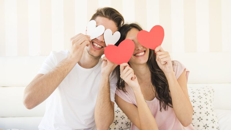 happy-couple-posing-with-paper-heart